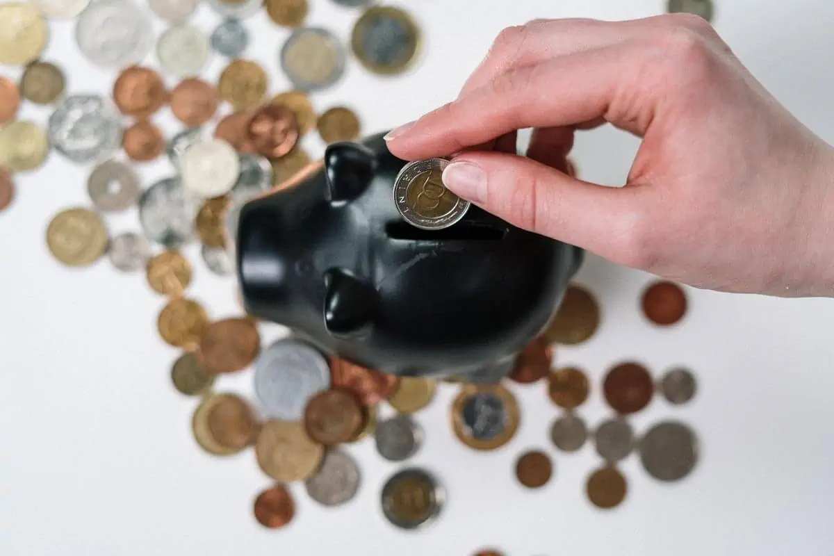 Person-Putting-Coin-in-a-Piggy-Bank