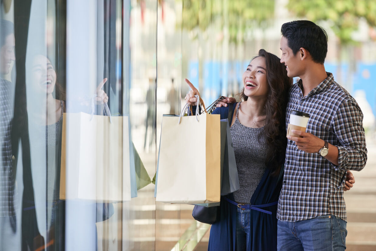 A happy couple window shopping with shopping bag and coffee at Royal Oceancrest Panglao 2